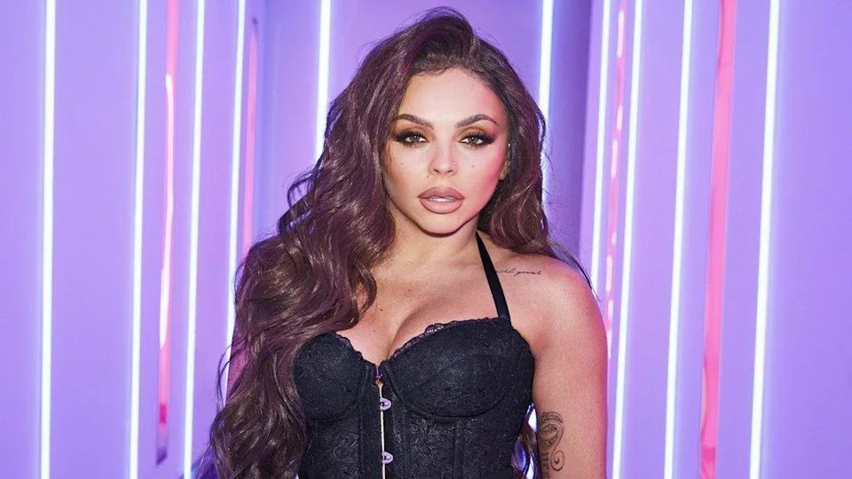 Jesy Nelson - a woman with long brown hair and black dress.