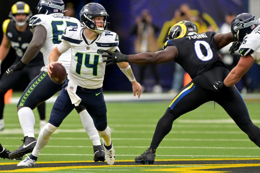 Seattle Seahawks quarterback Sam Darnold is pressured by Los Angeles Rams linebacker Byron Young in November.
