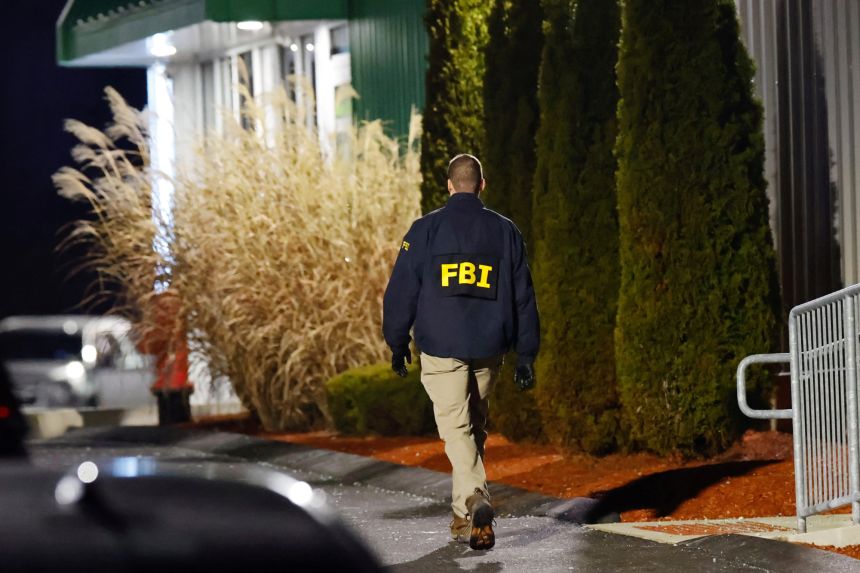 An investigator works the scene at a storage facility in Salem, New Hampshire where  Claudio Neves Valente took his own life, on December 18.