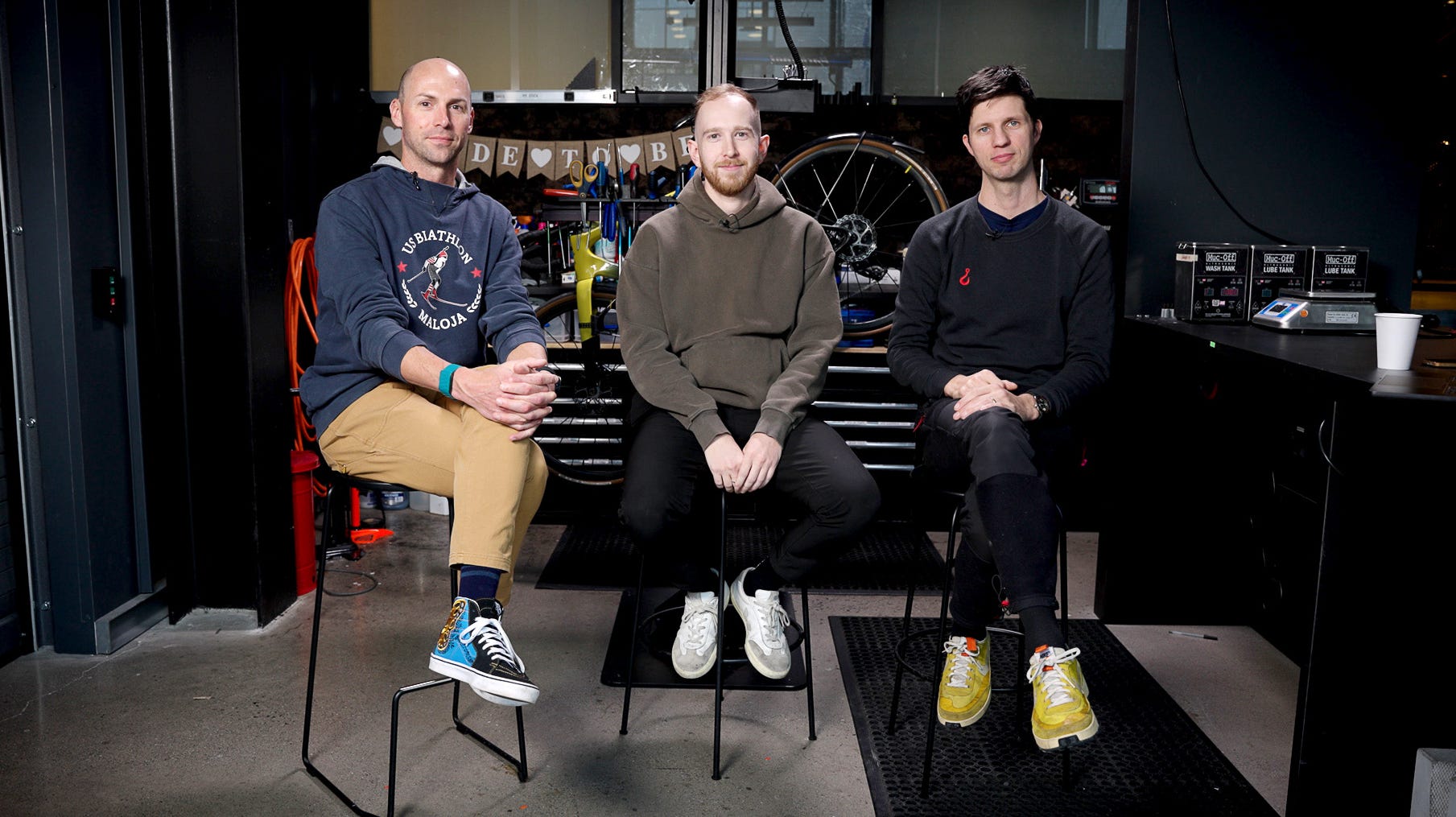 cyclist riding a bike on a road surrounded by greenery