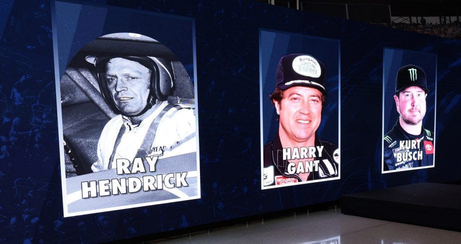 display board featuring racing drivers with blurred faces