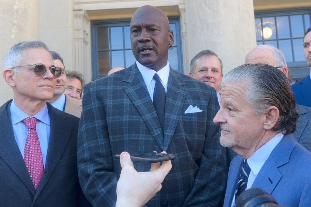 Michael Jordan (c.) speaks outside the federal courthouse in Charlotte after NASCAR settled an antitrust lawsuit on Dec. 11, 2025.