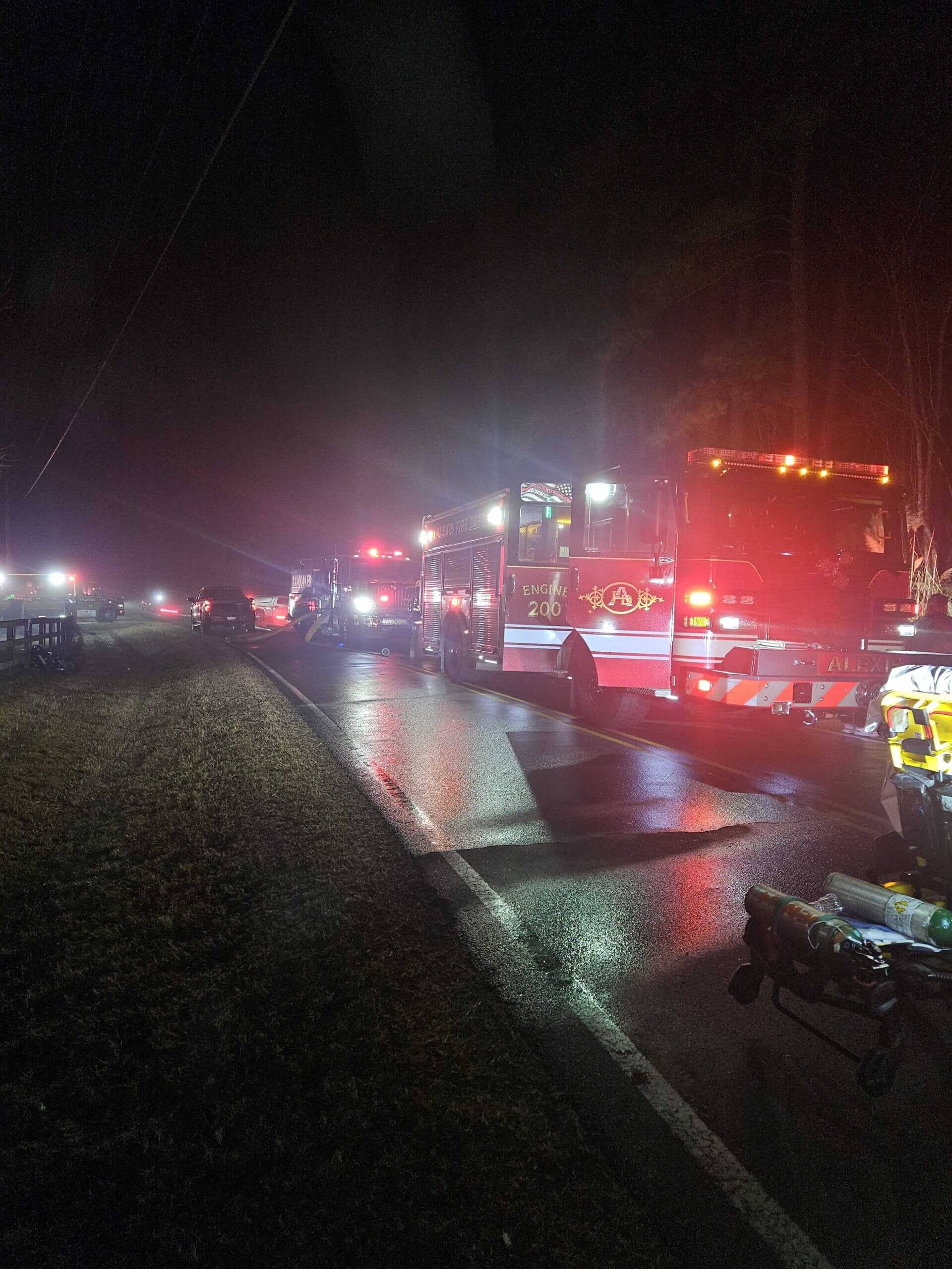 Emergency vehicles line the street outside the home of Denny Hamlin's parents.