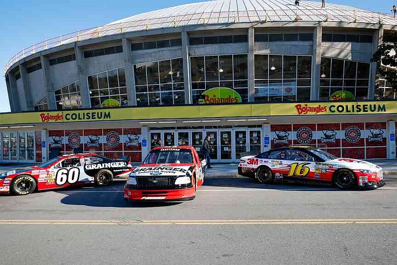 Race cars used by the late Greg Biffle are displayed outside BoJangles Coliseum for a NASCAR Plane Crash Memorial memorial for Biffle, his family and others who died in a plane crash, in Charlotte, N.C., Friday, Jan. 16, 2026. (AP Photo/Nell Redmond)