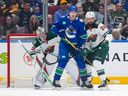 Big Vancouver Canucks winger Drew O'Connor sets a screen against the Minnesota Wild during an April 12, 2025 encounter at Rogers Arena.