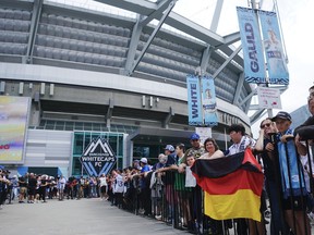 Fans of Thomas Müller #13 of the Vancouver Whitecaps FC hold a sign to welcome Müler outside the stadium prior to the MLS match between Vancouver Whitecaps FC and Houston Dynamo FC at BC Place on August 17, 2025 in Vancouver, British Columbia.