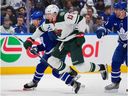 Morgan Rielly #44 of the Toronto Maple Leafs battles with Yakov Trenin #13 of the Minnesota Wild in the first period at Scotiabank Arena on January 19, 2026 in Toronto.