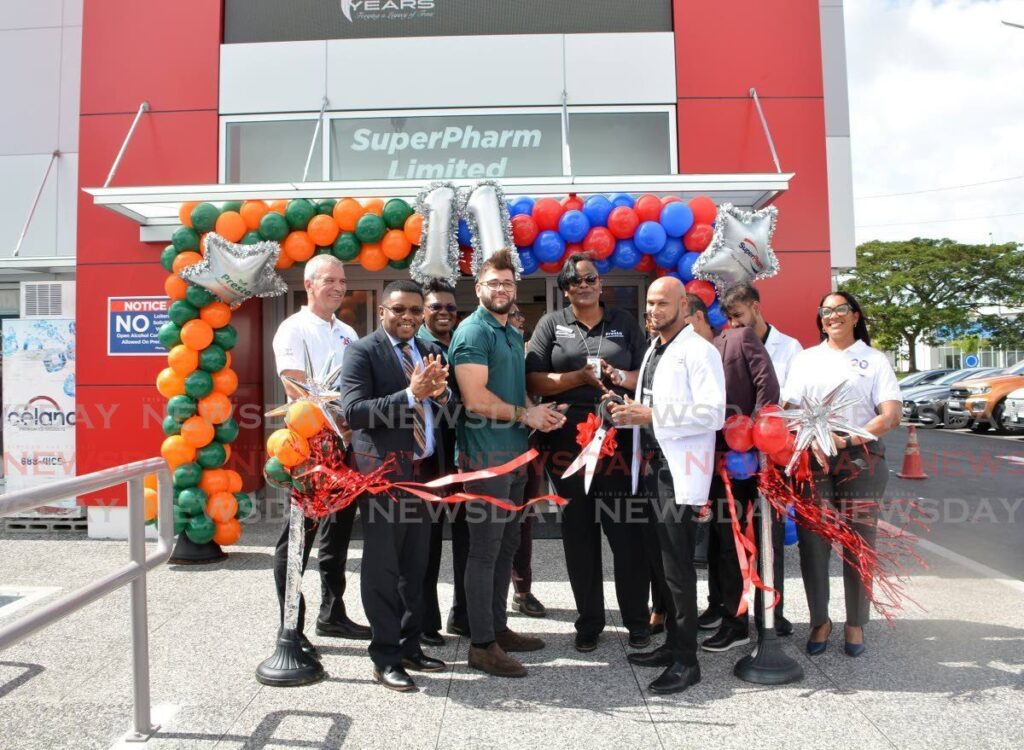 Cutting the ribbons to open the new SuperPharm Store at South Park, front row, from left, San Fernando Mayor Robert Parris, Presto’s business Development Director Jean-Luc Moutte, Store Manager Jolene Wallace, Senior Pharmacist Mathew Ragoonanan, SuperPharm CEO Glenn Maharaj and Master of Ceremonies Michelle Perryman on January 15. - Innis Francis