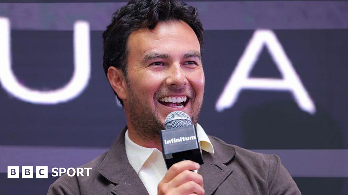 Sergio Perez speaking into a microphone at a Cadillac news conference in 2025