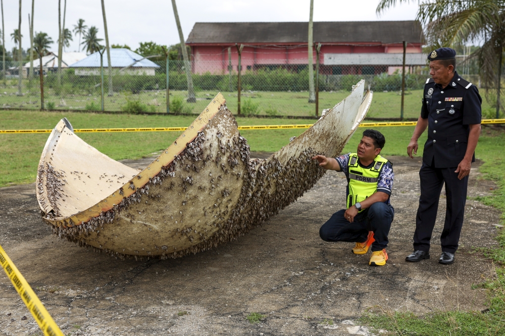 Nenasi police officers inspect a suspected piece of space debris found along the Nenasi coast in Pekan, Pahang on December 30, 2025. — Bernama pic