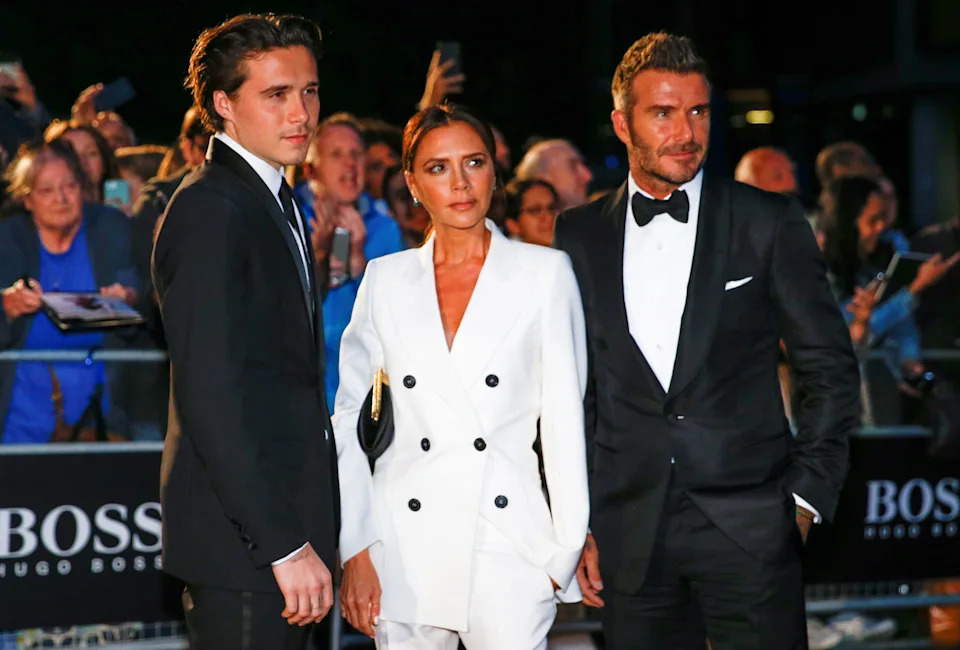 Brooklyn Beckham, from left, and his parents, Victoria and David Beckham, arrive to the GQ Men of the Year Awards in London on Sept. 3, 2019.