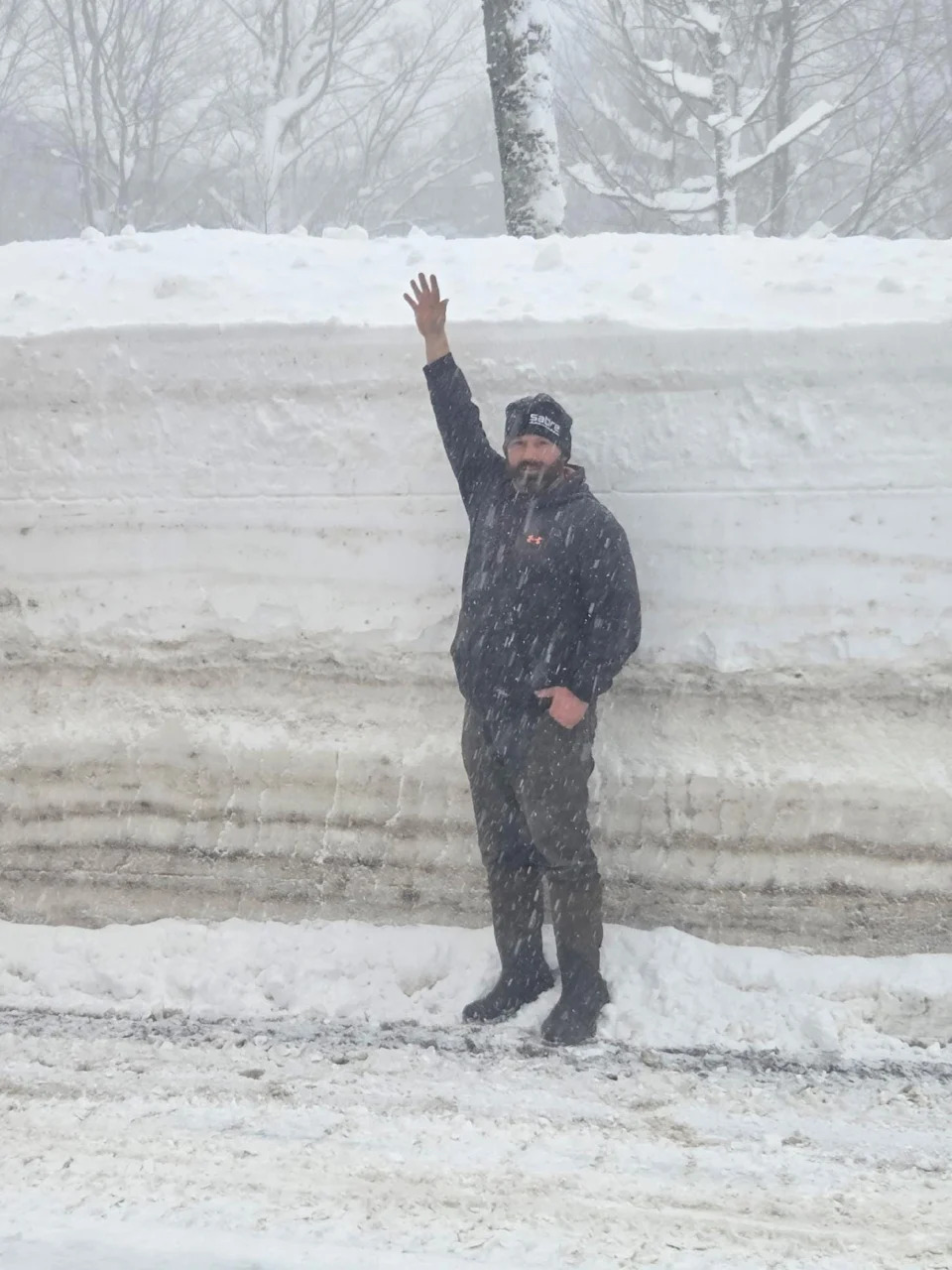 New York State Department of Transportation Equipment Operator Instructor Jeremy Johnson measures himself against a snowbank in northern Oswego County on Jan. 24, 2026.