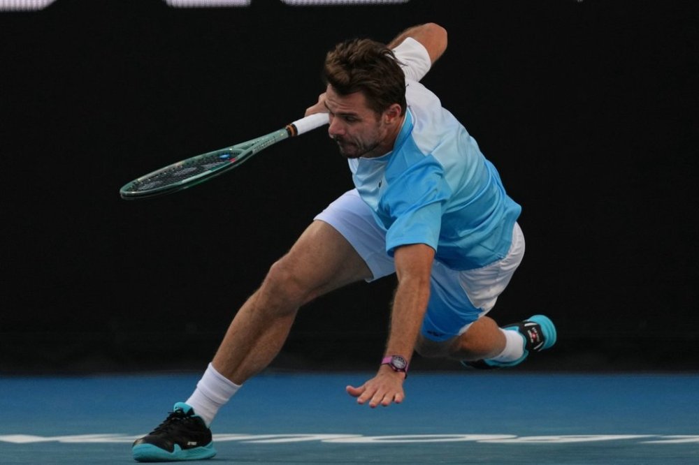 Stan Wawrinka of Switzerland falls during his second round match against Arthur Gea of France at the Australian Open tennis championship in Melbourne, Australia, Thursday, Jan. 22, 2026. (AP Photo/Dita Alangkara)