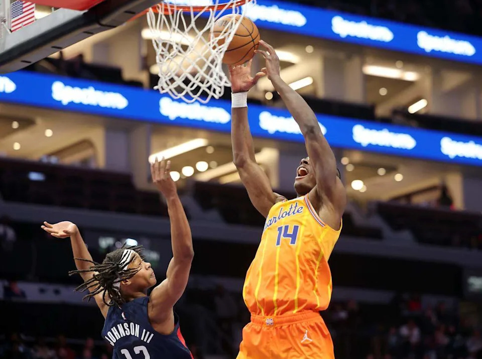 Charlotte Hornets’ Moussa Diabate puts up the shot as Tre Johnson III defends during the game against the Washington Wizards on Saturday, Jan. 24, 2026 at Spectrum Center in Charlotte, North Carolina.