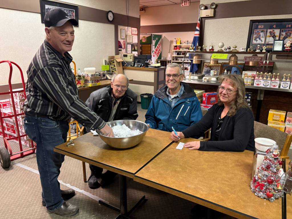 Cliff Jordhal draws a name for the Castor Elks as Elks members Pat Annette, George Nichols, and Jackie Baldwin look on. (Lynn Sabo photo)