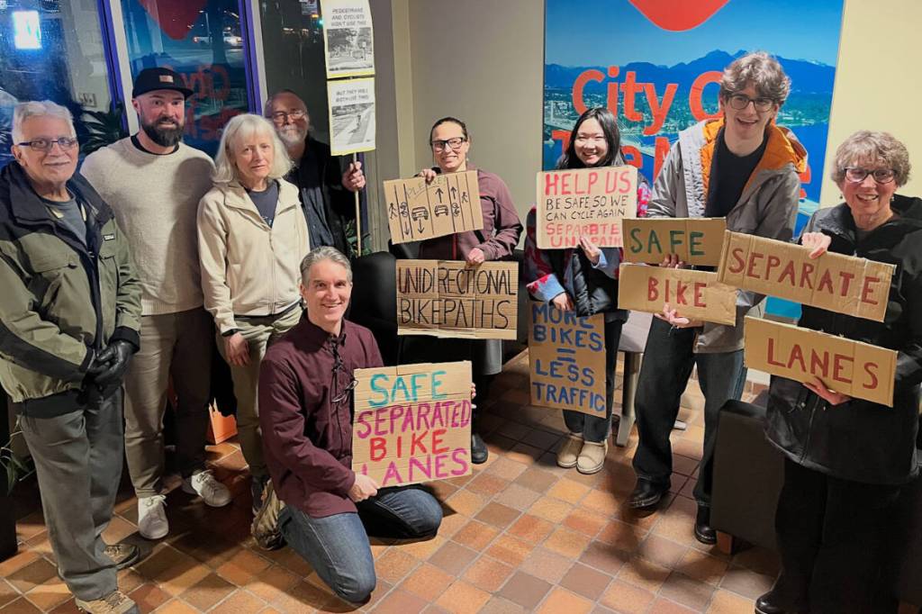 Bike lane lobbyists brought signs to city hall to speak with council about the Lougheed Transit Corridor Area Plan. (Special to The News)
