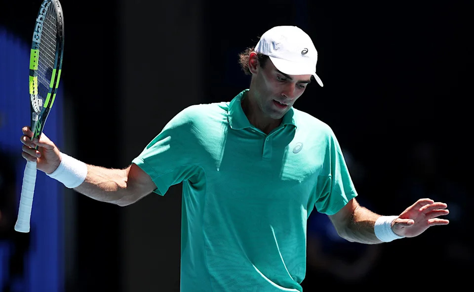 Eliot Spizzirri in action against Jannik Sinner at the Australian Open.