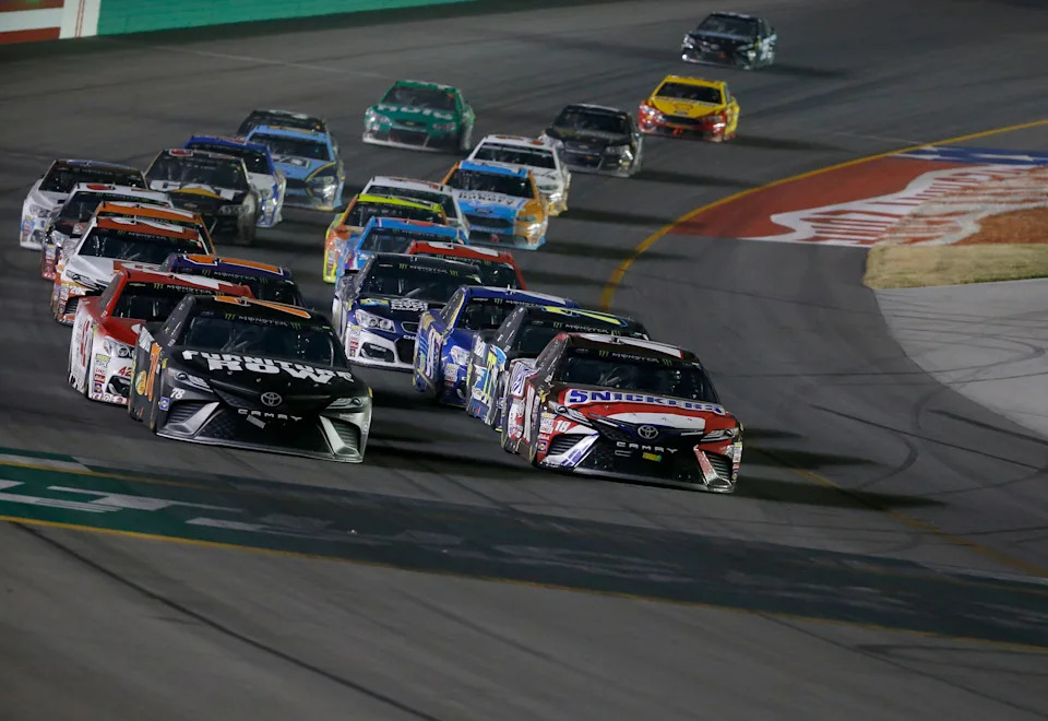 Monster Energy NASCAR Cup Series driver Martin Truex Jr. (78) leads the race with driver Kyle Busch (18) in second during a restart late in the third stage of the NASCAR Cup Series Quaker State 400 at the Kentucky Speedway in Sparta, Ky., on Saturday, July 8, 2017. Monster Energy NASCAR Cup Series driver Martin Truex Jr. (78) tallied a victory in overtime after a caution on lap 265.(The Cincinnati Enquirer/Sam Greene) 