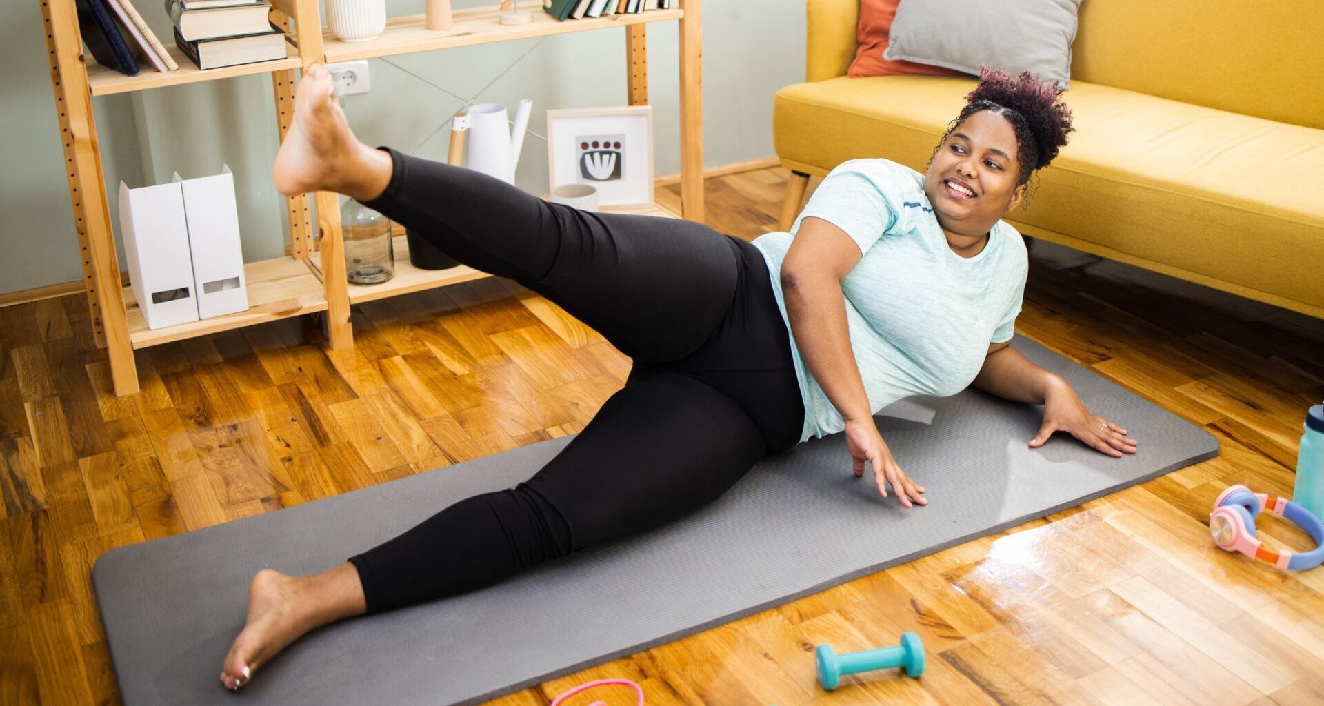 woman on mat does a side leg lift