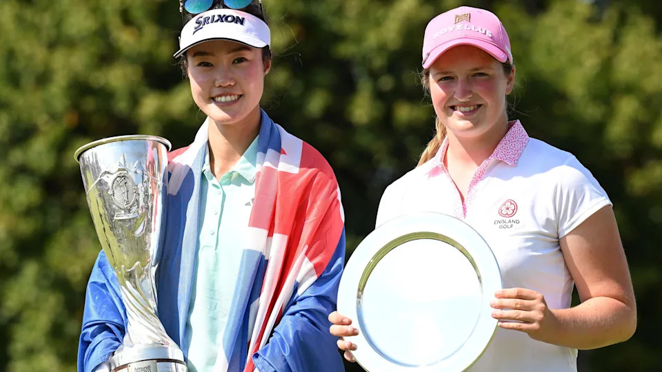 Grace Kim of Australia and England's Lottie Woad hold their trophies after the former won the Evian Championship and the latter finished as the best amateur player at the women's major