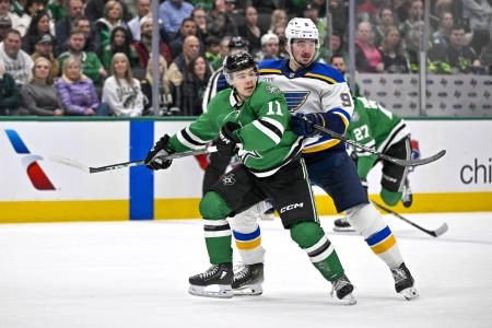 December 14, 2024; Dallas, Texas, USA; St. Louis Blues center Alexandre Texier (9) and Dallas Stars center Logan Stankoven (11) battle for the puck in the Blues' zone during the second period at American Airlines Center.