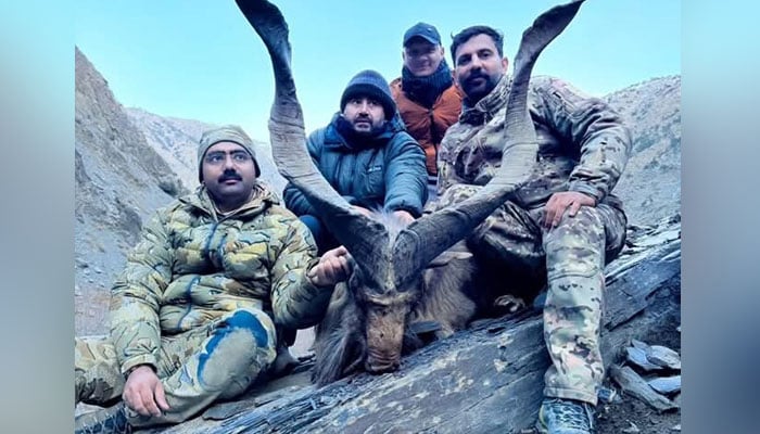 Locals pictured with hunted Kashmiri Markhor. — Reporter