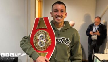 Prime Minister Mark Carney, wearing a black suit jacket, and a white button-up shirt leans his chin on his hands. He has short grey and black hair and is looking away from the camera.