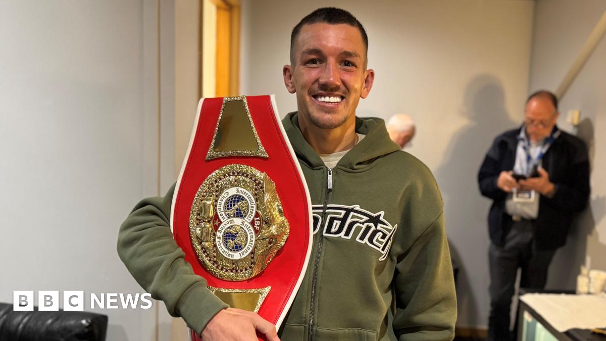Prime Minister Mark Carney, wearing a black suit jacket, and a white button-up shirt leans his chin on his hands. He has short grey and black hair and is looking away from the camera.