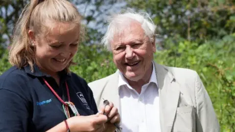 Eric Renno/Leicestershire and Rutland Wildlife Trust Sir David Attenborough with a member of Leicestershire and Rutland Wildlife Trust at a bird ringing demonstration at the Volunteer Training Centre in Rutland