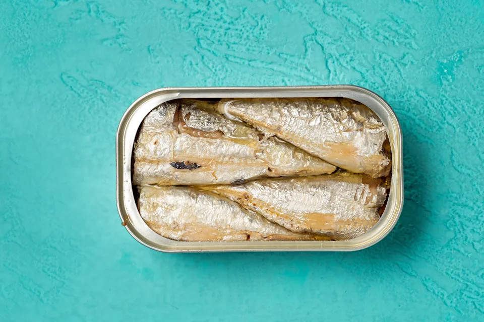 canned sardines on a blue background
