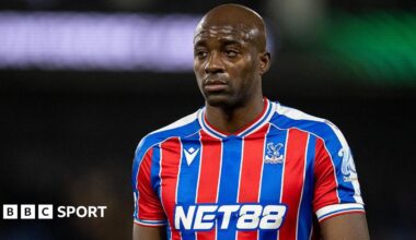 Jean-Philippe Mateta wearing a blue and red striped Crystal Palace shirt