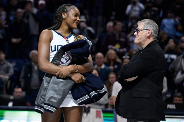 Former UConn player and WNBA player Aaliyah Edwards, left, smiles as UConn head coach Geno Auriemma, right during a pregame ceremony adding Edwards to the Huskies of Honor before an NCAA college basketball game against Xavier, Wednesday, Jan. 28, 2026, in Storrs, Conn. (AP Photo/Jessica Hill)