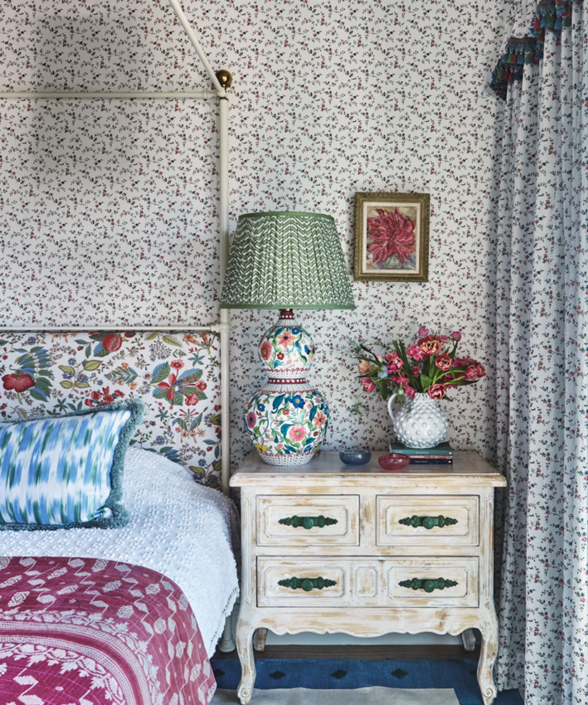 floral master bedroom with a four poster bed and a small dressing room