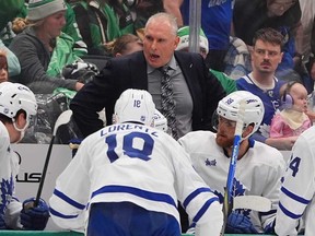Toronto Maple Leafs head coach Craig Berube, centre top, speaks to the bench during the second period of an NHL hockey game against the Dallas Stars, Sunday, Dec. 21, 2025, in Dallas.