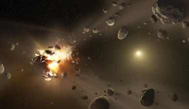 An artist's impression of an asteroid fragmenting into multiple chunks. The chunks come from a glowing light to the left of the image