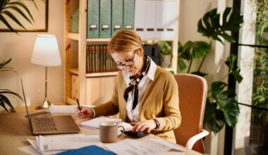 Middle aged businesswoman using laptop while working from home