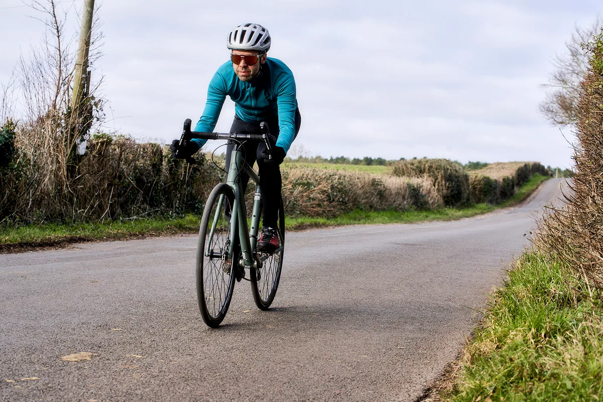 Male cyclist in blue top riding the Cannondale Synapse 1 road bike