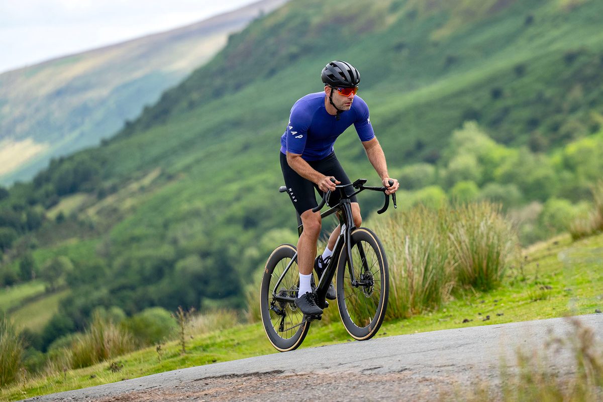 Male cyclist in blue top riding the Cervélo S5 2025 (Dura-Ace Di2) aero road bike