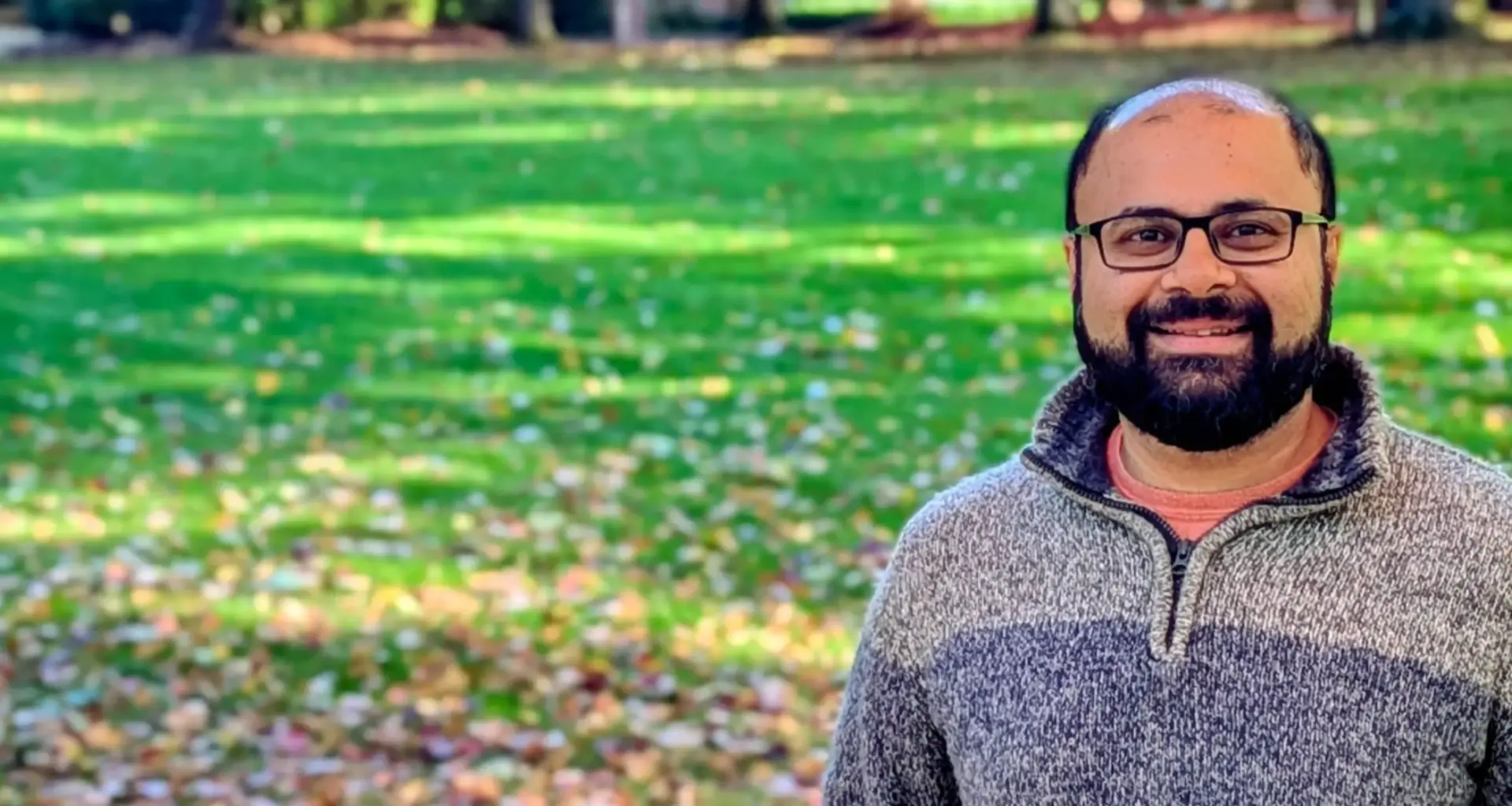 Profile photo of Saurabh in front of a green lawn with fall coloured leaves.