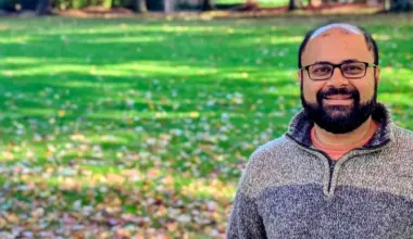 Profile photo of Saurabh in front of a green lawn with fall coloured leaves.