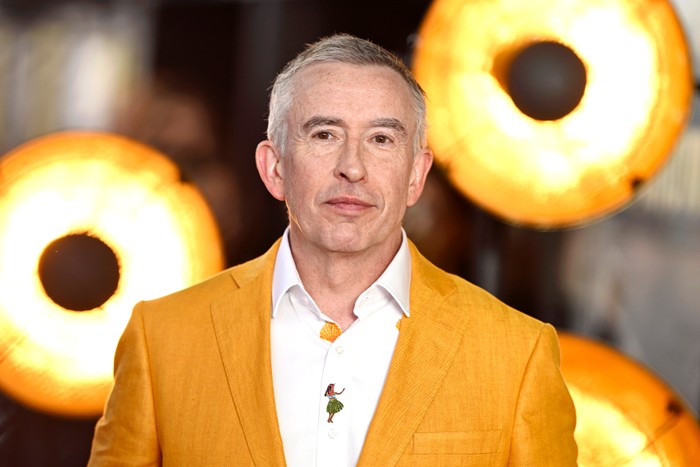 Steve Coogan Steve Coogan waering a yellow blazer and white shirt.