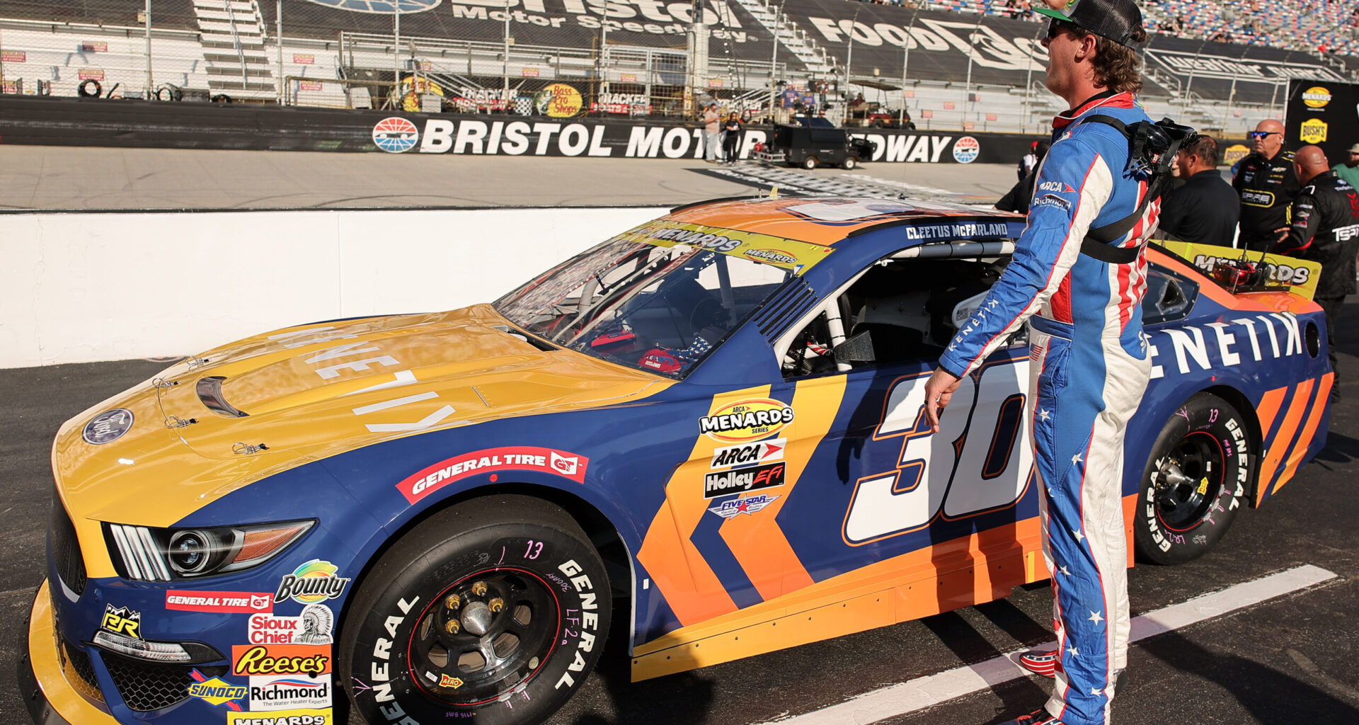 BRISTOL, TENNESSEE - SEPTEMBER 11: Garrett Mitchell, also known as Cleetus McFarland, driver of the #30 Kenetik Ford waves to fans on the grid prior to the ARCA Menards Series Bush's Beans 200 at Bristol Motor Speedway on September 11, 2025 in Bristol, Tennessee. (Photo by Jonathan Bachman/Getty Images)