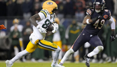 Romeo Doubs #87 of the Green Bay Packers runs the ball after a catch against Tremaine Edmunds #49 of the Chicago Bears during the fourth quarter in the NFC Wild Card Playoff game at Soldier Field on January 10, 2026 in Chicago, Illinois.
