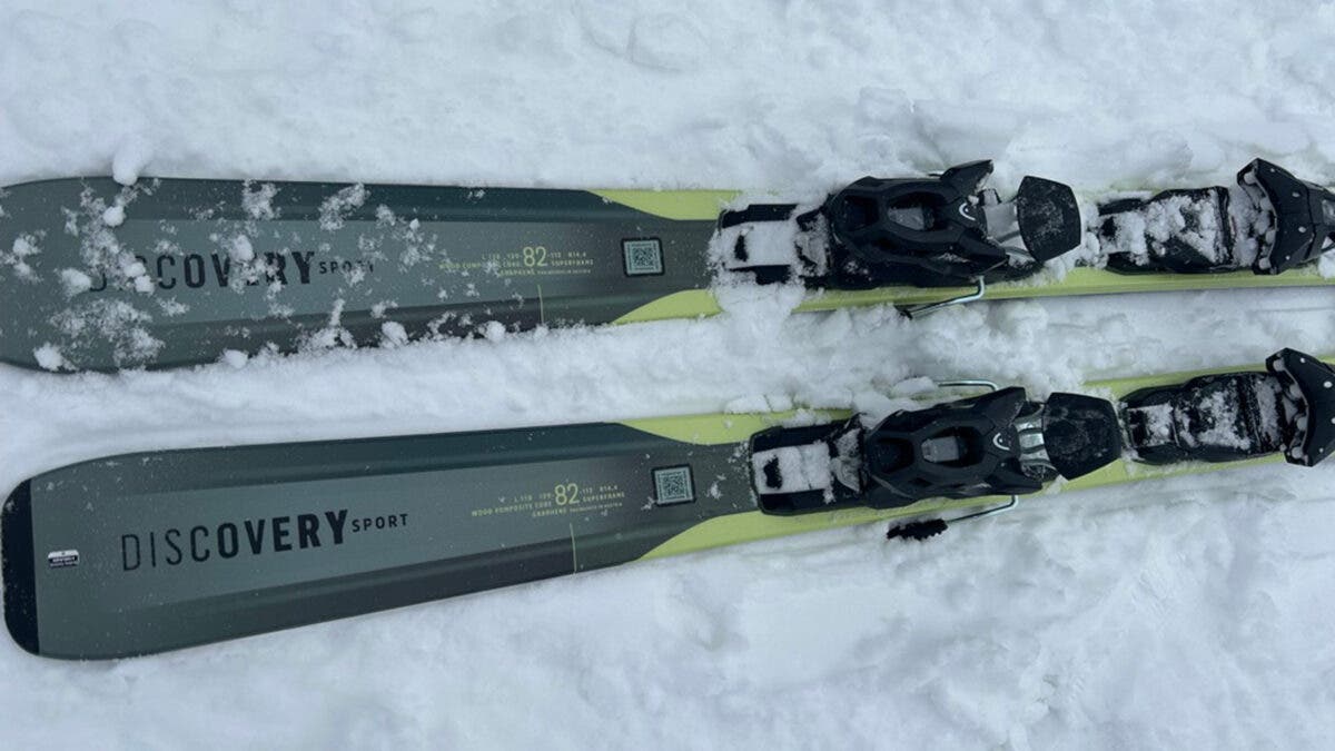 Closeup of tails of Head Discovery frontside skis covered in snow