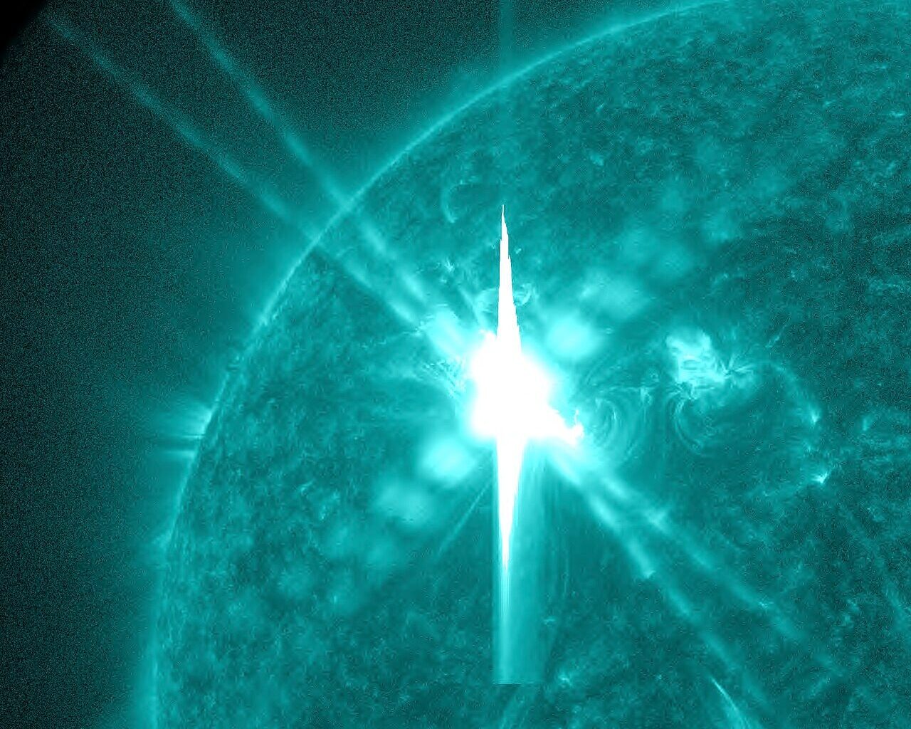 Image artifacts (diffraction spikes and vertical streaks) appearing in a CCD image of a major solar flare due to the excess incident radiation.