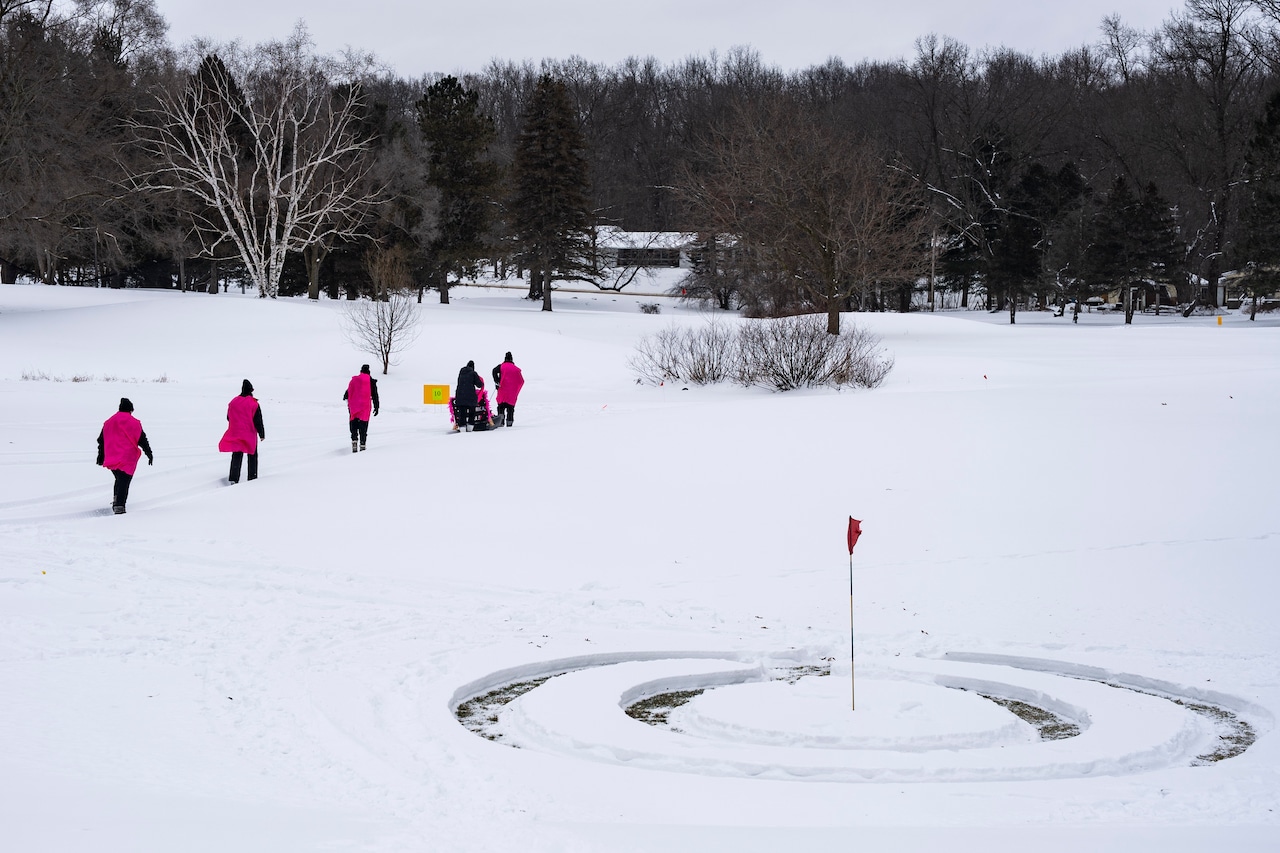 Golfers play through the snow at the annual Kiwanis Chili Golf Classic