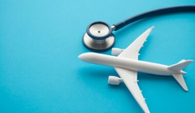 Airplane and stethoscope on blue background with copy space. Going abroad for medical care. Medical tourism is when a person travels to another country for medical care.