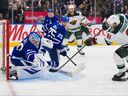 Wild’s Vladimir Tarasenko scores against Maple Leafs goalie Joseph Woll at Scotiabank Arena last night.