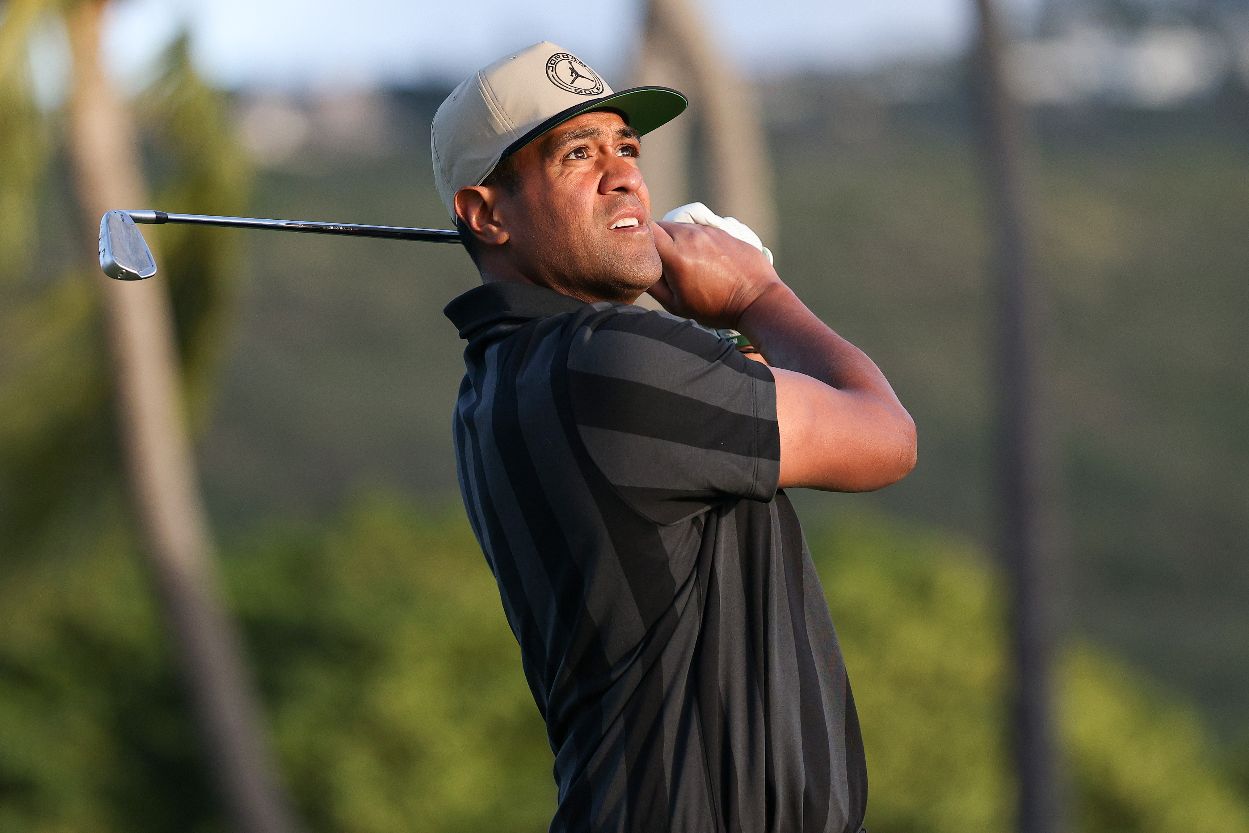 Tony Finau watches an iron shot