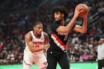 Portland Trail Blazers guard Shaedon Sharpe, right, looks to pass away from New York Knicks guard Miles McBride during the first half of an NBA basketball game, Sunday, Jan. 11, 2026, in Portland, Ore.